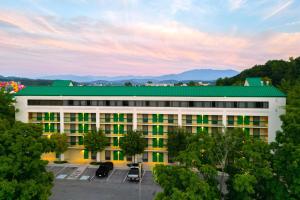 a large white building with a green roof at Quality Inn Near the Island Pigeon Forge in Pigeon Forge