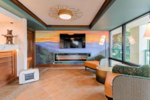 a living room with a fireplace and a painting on the wall at Quality Inn Near the Island Pigeon Forge in Pigeon Forge