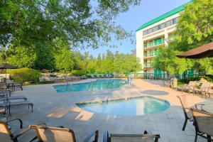 a swimming pool with chairs and a building at Quality Inn Near the Island Pigeon Forge in Pigeon Forge