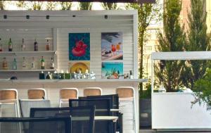 a restaurant with a bar with tables and chairs at Bishkek Park Apartments in Bishkek