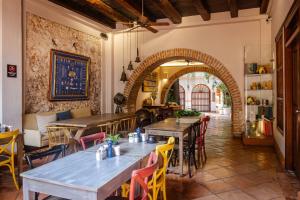 a restaurant with tables and chairs in a room at Hotel Bantu by Faranda Boutique, a member of Radisson Individuals in Cartagena de Indias