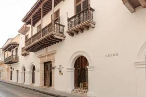 a white building with balconies on a street at Hotel Casa Don Luis by Faranda Boutique, a member of Radisson Individuals in Cartagena de Indias