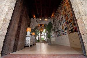a hallway in a building with a wall with pictures on it at Hotel Casa Don Luis by Faranda Boutique, a member of Radisson Individuals in Cartagena de Indias