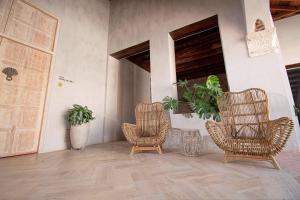 two wicker chairs sitting in a room with plants at Hotel Casa Don Luis by Faranda Boutique, a member of Radisson Individuals in Cartagena de Indias