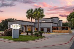 a building with a sign for a motel at The Angler Hotel Livingston, an Ascend Collection Hotel in Livingston