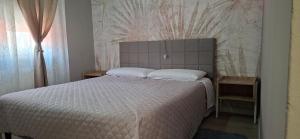 a bedroom with a large bed with white sheets at Via Roma Residence in Maniago