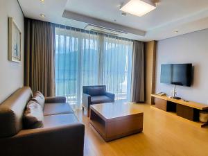 a living room with a couch and a tv at STX Resort in Mungyeong