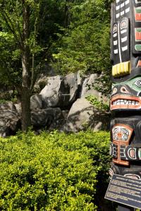 a totem pole in the middle of a garden at DoubleTree by Hilton North Vancouver in North Vancouver
