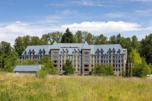 a hotel with a building in the middle of a field at DoubleTree by Hilton North Vancouver in North Vancouver