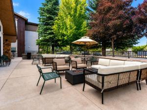 a patio with tables and chairs and an umbrella at Hampton Inn By Hilton Hailey Sun Valley in Hailey