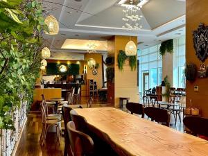 a restaurant with a large wooden table and chairs at STX Resort in Mungyeong