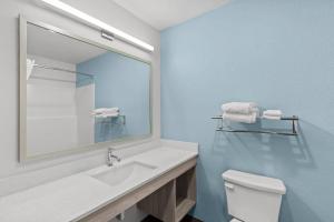 a bathroom with a white sink and a mirror at WoodSpring Suites Atlanta Canton in Canton +20 photos