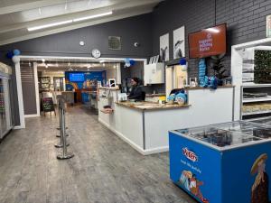 a person standing at a counter in a store at Ingenia Holidays Murray Bend in Koonoomoo