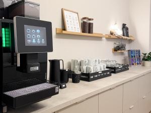 a coffee machine sitting on a counter in a kitchen at Hotel Salina B&B - mit Parkplatz, Zentral und Digital in Bad Rothenfelde