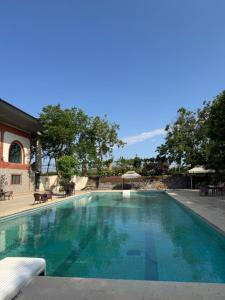 a large swimming pool with blue water at Chabiant Winery Hotel in Hacıhǝtǝmli