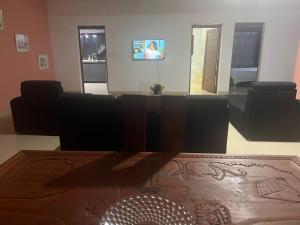 a living room with a couch and a tv at Akany Fitahiantsoa in Ivato
