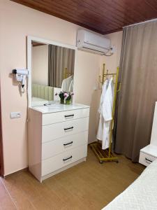 a bathroom with a white dresser and a mirror at RIVERSIDE Cottage in Martvili +26 photos