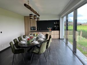 a dining room with a long table and chairs at Villa Houtave in Zuienkerke