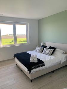 a bedroom with a bed with two pairs of shoes on it at Villa Houtave in Zuienkerke