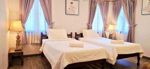 two beds in a room with two windows at 90 9 Pool Villa Chiang Mai in Ban Pa Ngae +49 photos