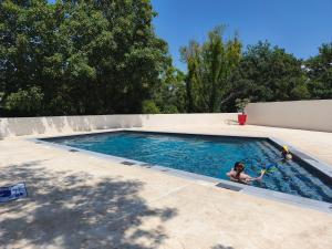 a young girl playing in a swimming pool at l'instant provence in Pradons +6 photos