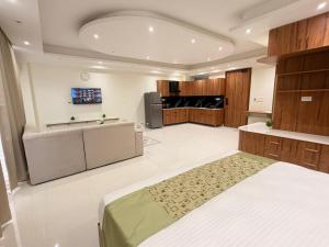 a large room with a bed and a television at Hotel Mikado Palace in Gurgaon