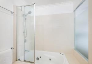 a shower with a glass door in a bathroom at Ivory Palms Resort Noosa in Noosaville +223 photos