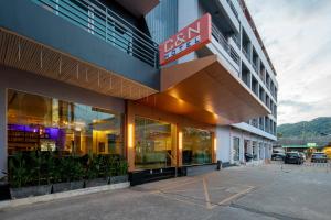 a building with a sign on the side of it at C & N Hotel Patong, Phuket in Patong Beach