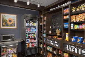 a grocery store aisle with a refrigerator and food at Hampton Inn Kernersville in Kernersville