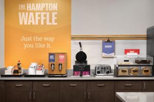 a kitchen with a counter top with a coffee maker at Hampton Inn Kernersville in Kernersville +21 photos