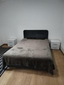 a bedroom with a bed and two night stands at Vila Lokvanj in Gornja Vranjska +70 photos