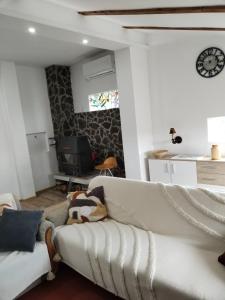 a living room with a couch and a clock on the wall at Vila Lokvanj in Gornja Vranjska