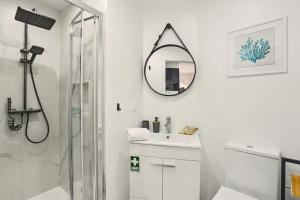 a bathroom with a shower and a sink and a mirror at Lobo's House in Câmara de Lobos +19 photos