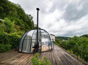 a glass dome sitting on a wooden deck at Entre Ciel et Rivière in Bouillon