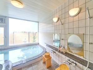 a bathroom with a swimming pool and a window at Shirahama Onsen Kisyu Hanto in Shirahama