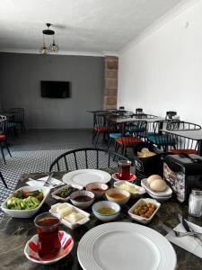 a table with plates and bowls of food on it at Dada Otel in Ezine