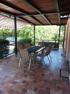 a patio with a table and chairs under a pergola at Villa Meja in Hreljin