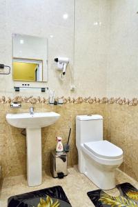 a bathroom with a white toilet and a sink at Dilbar Guest House in Samarkand +22 photos