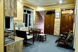 a living room with a table and a couch at Dilbar Guest House in Samarkand