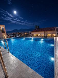 a large swimming pool at night with the moon at Beautiful Kathmandu Hotel in Kathmandu