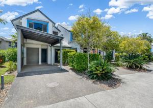 a house with a roof over a driveway at Ivory Palms Resort Noosa in Noosaville
