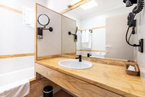 a bathroom with a sink and a mirror at Smart Hotel Cabo Sur in Mojácar