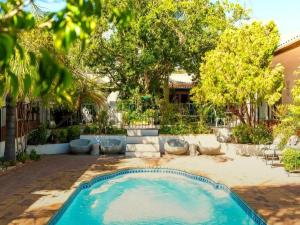 a swimming pool in a yard with trees at Blommenberg in Clanwilliam