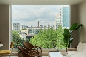 a large window in a living room with a view of a city at 쉼스테이 in Myŏnghag-yŏk