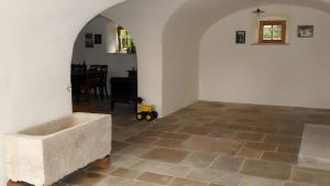 a room with a stone tub on a tile floor at Ferienwohnung Langhof in Schernfeld +7 photos