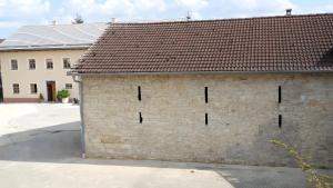 a brick building with a brown roof at Ferienwohnung Langhof in Schernfeld