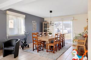 a dining room with a table and chairs at Le Karush proche chambord in Mer