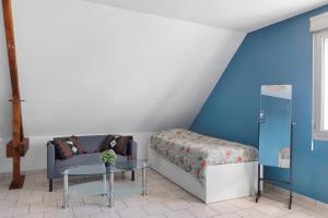 a bedroom with a bed and a table at Le Karush proche chambord in Mer