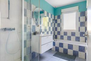 a bathroom with a shower and a sink and a tub at Le Karush proche chambord in Mer +18 photos