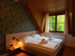 a bedroom with a bed with two stuffed animals on it at Horský hotel Vidly in Karlova Studánka +43 photos